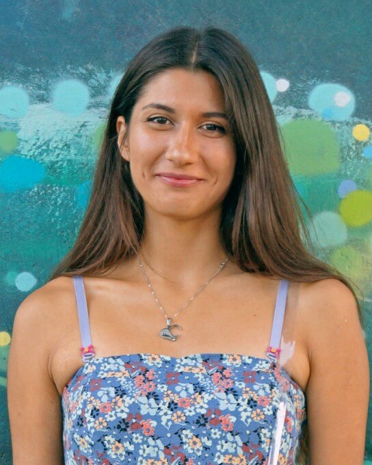 a woman with long hair wearing the blue slip dress