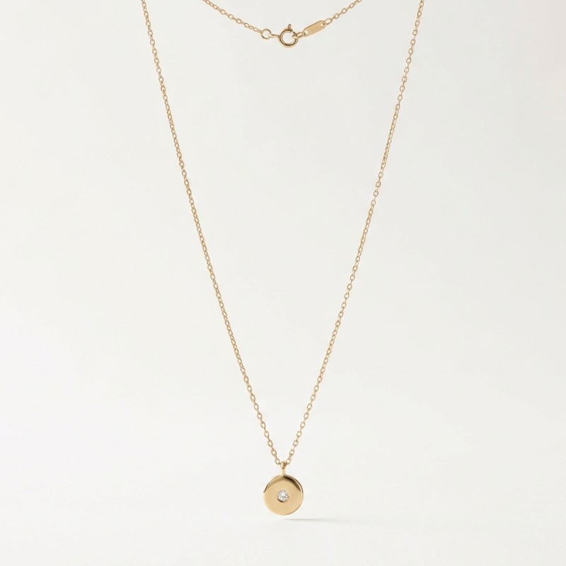 A minimal product image of a delicate gold pendant necklace on a clean white background
