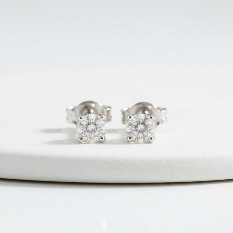 A minimal product image of diamond stud earrings with small round diamonds on a clean white background