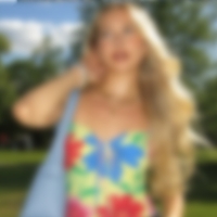 A low quality thumbnail of a blonde woman wearing a floral top