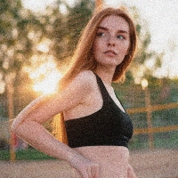 A noisy thumbnail of a woman wearing a black sports top and jeans