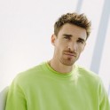 The thumbnail of a man in green pullover