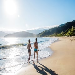 Thumbnail picture of couple jogging along horeline