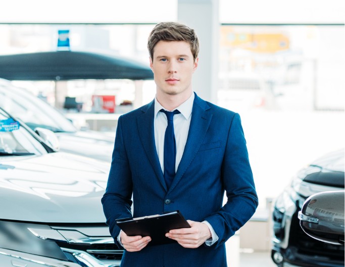 A man standing before the cars