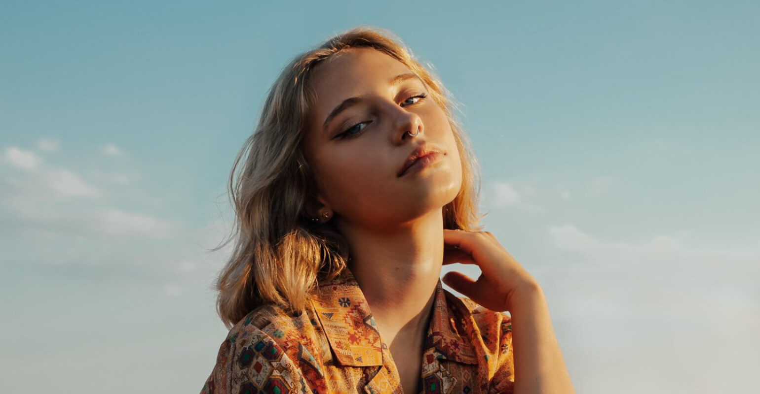 A girl with short hair in a floral shirt